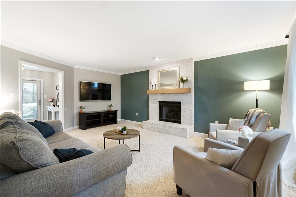 528 Pine Bluff Drive Mars, PA 16046 - Photo 6 of 25 a living room with furniture a fireplace and a flat screen tv