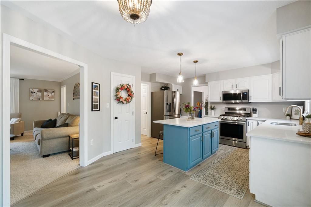528 Pine Bluff Drive Mars, PA 16046 - Photo 8 of 25 a kitchen with stainless steel appliances granite countertop a refrigerator oven a stove top oven a sink dishwasher and white cabinets with wooden floor