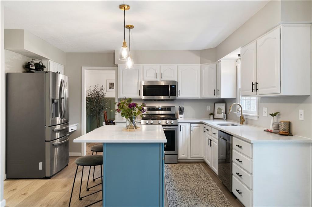 528 Pine Bluff Drive Mars, PA 16046 - Photo 10 of 25 a kitchen with a sink a microwave a refrigerator and cabinets