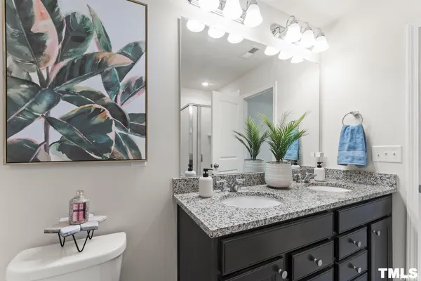 a bathroom with a granite countertop sink a mirror and vanity