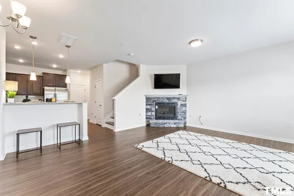 a view of kitchen living room with wooden floor and flat screen tv