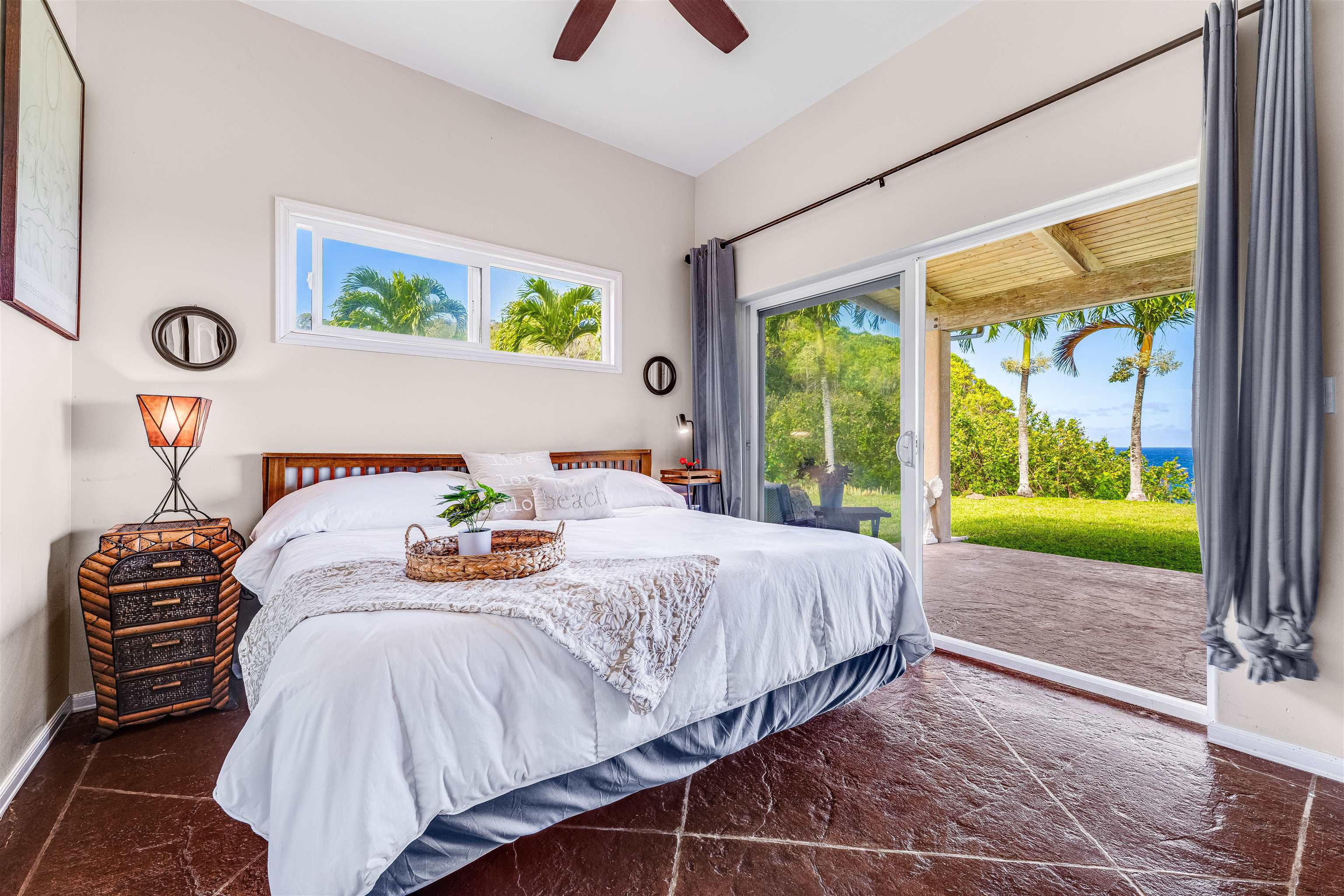1004 North Honokala Road, Unit B Haiku, HI 96708 - Photo 11 of 48 a bedroom with a bed and a large window