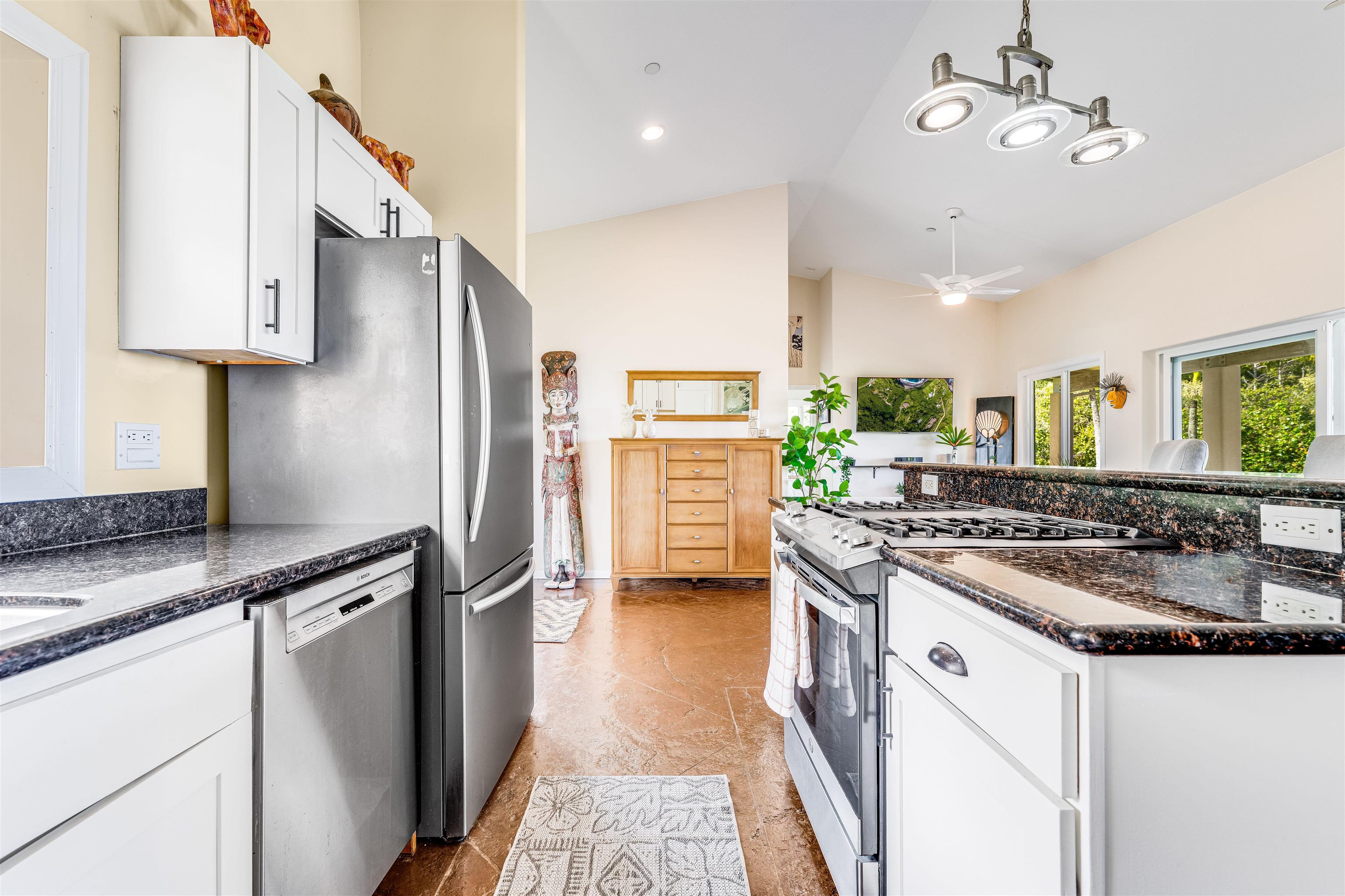 1004 North Honokala Road, Unit B Haiku, HI 96708 - Photo 21 of 49 a kitchen with stainless steel appliances granite countertop a stove and a refrigerator