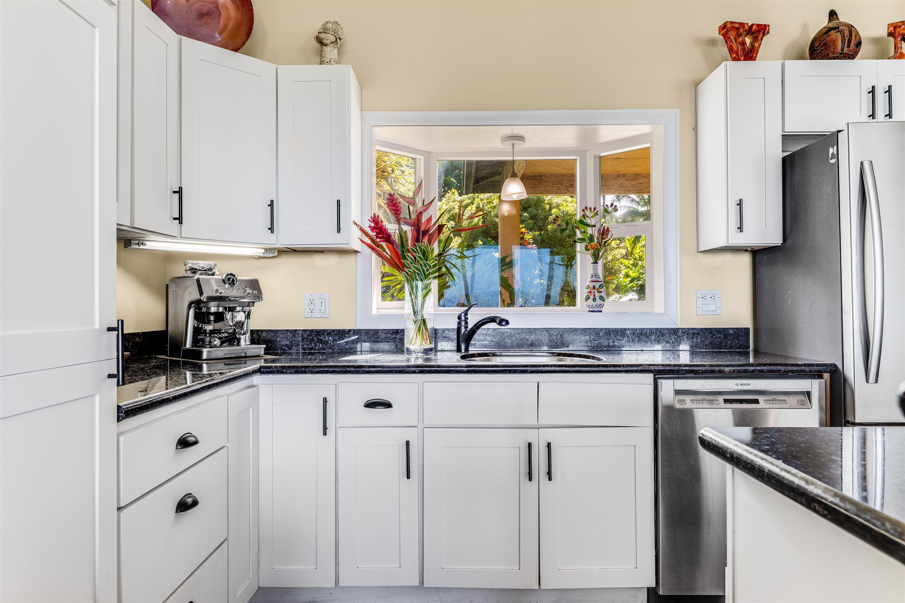 1004 North Honokala Road, Unit B Haiku, HI 96708 - Photo 22 of 49 a kitchen with granite countertop a sink stainless steel appliances and cabinets