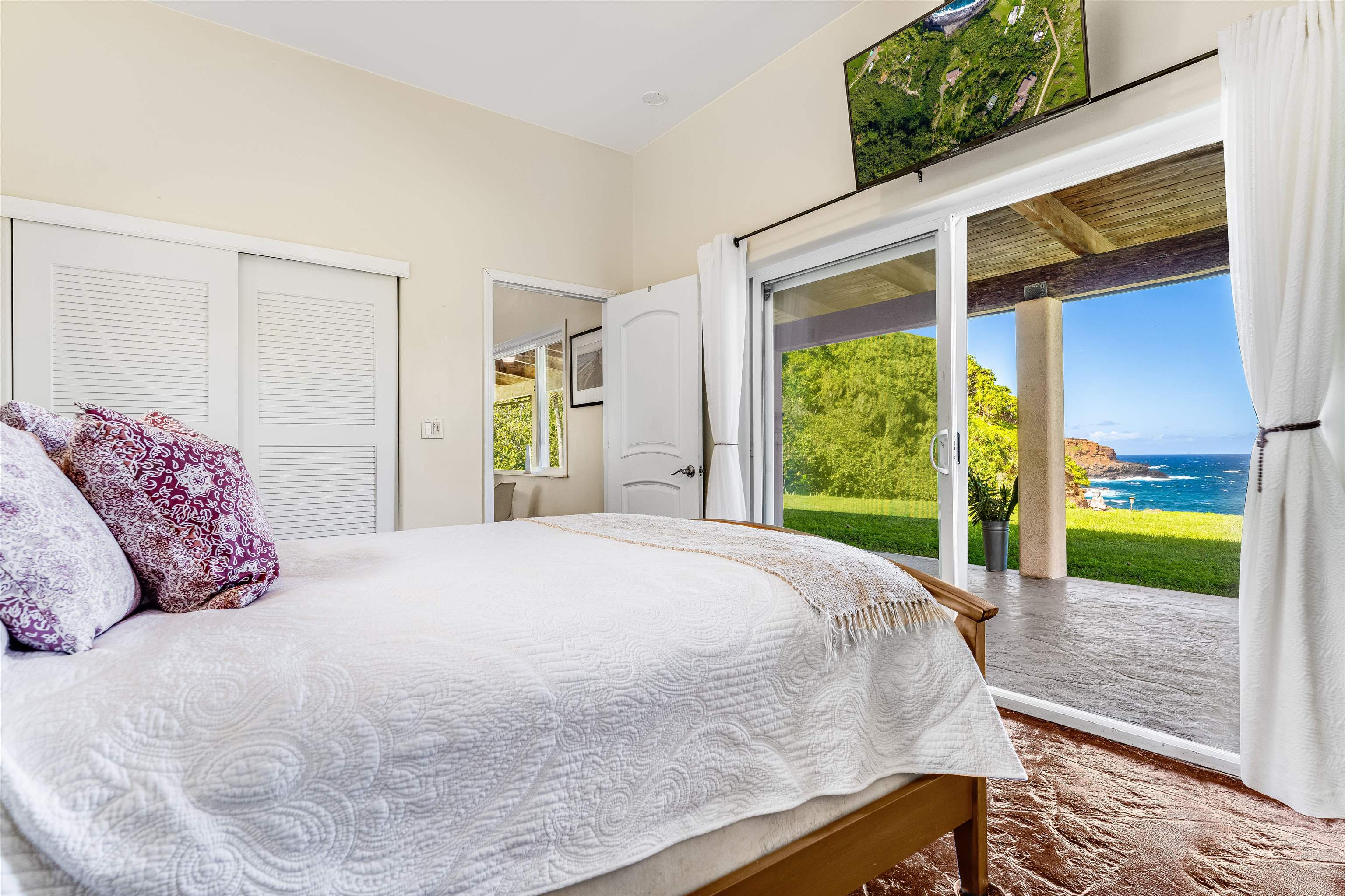 1004 North Honokala Road, Unit B Haiku, HI 96708 - Photo 29 of 49 a bed sitting in a bedroom next to a window