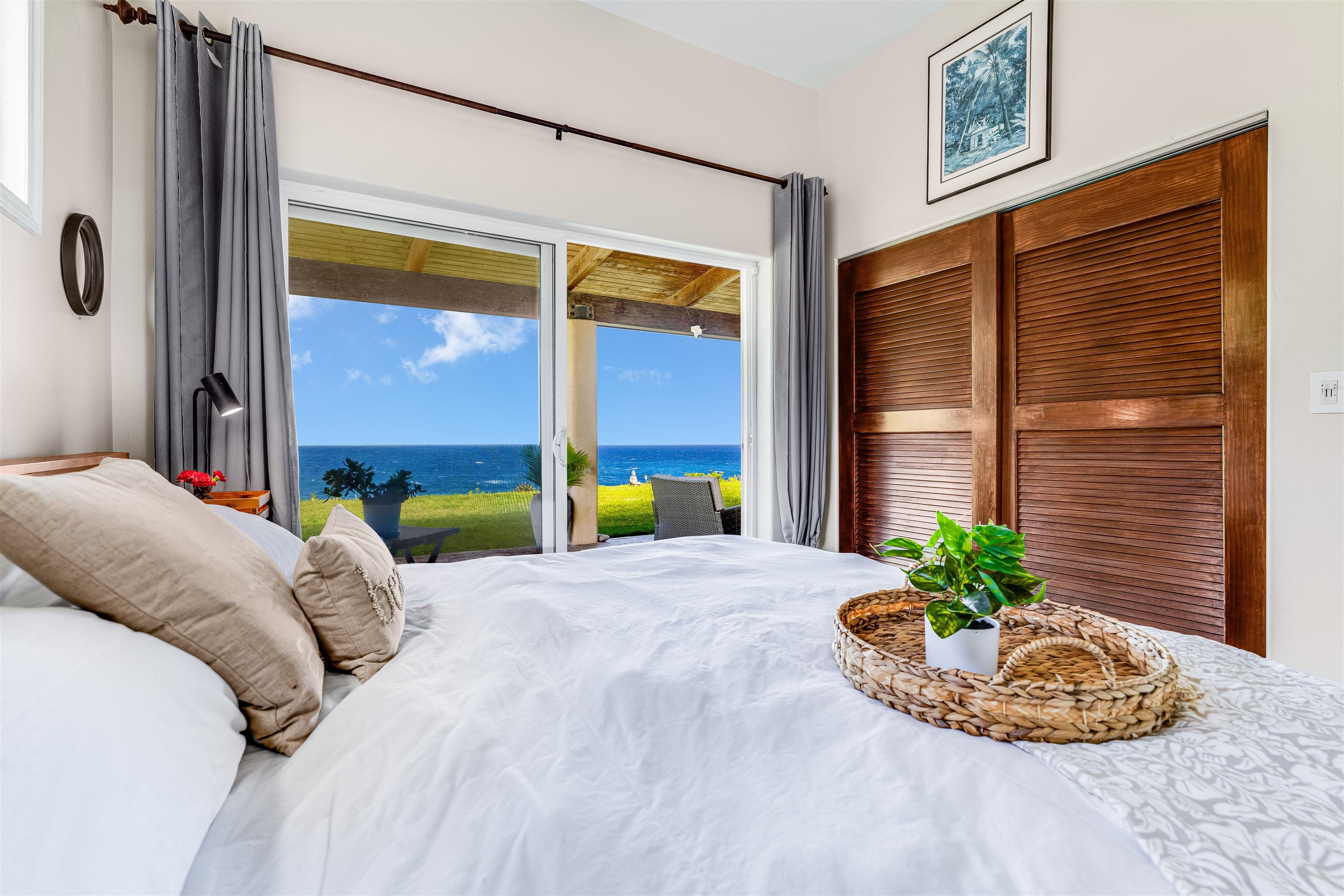 1004 North Honokala Road, Unit B Haiku, HI 96708 - Photo 3 of 48 a bed sitting in a bedroom next to a window