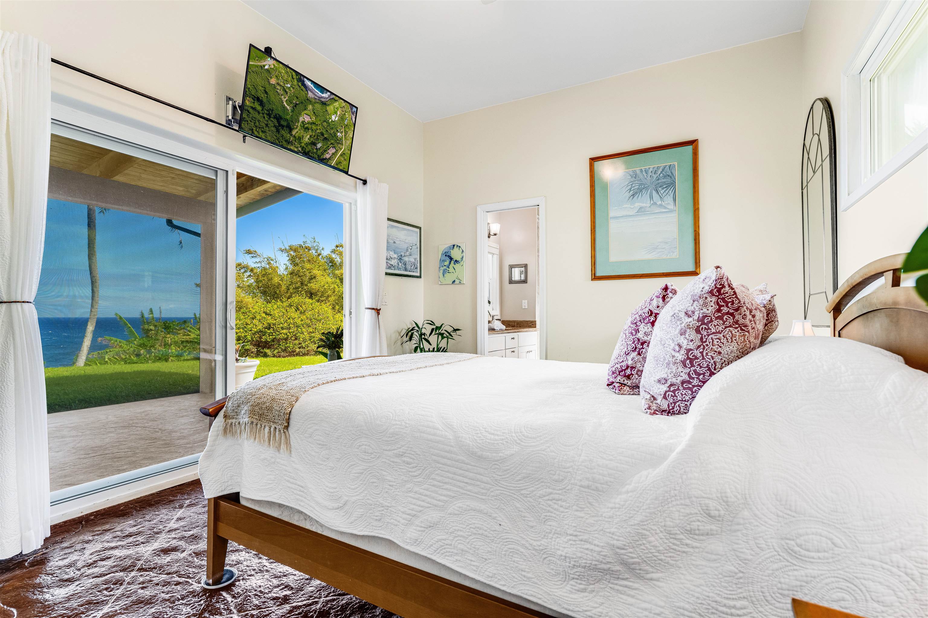 1004 North Honokala Road, Unit B Haiku, HI 96708 - Photo 31 of 49 a bedroom with a bed and a window