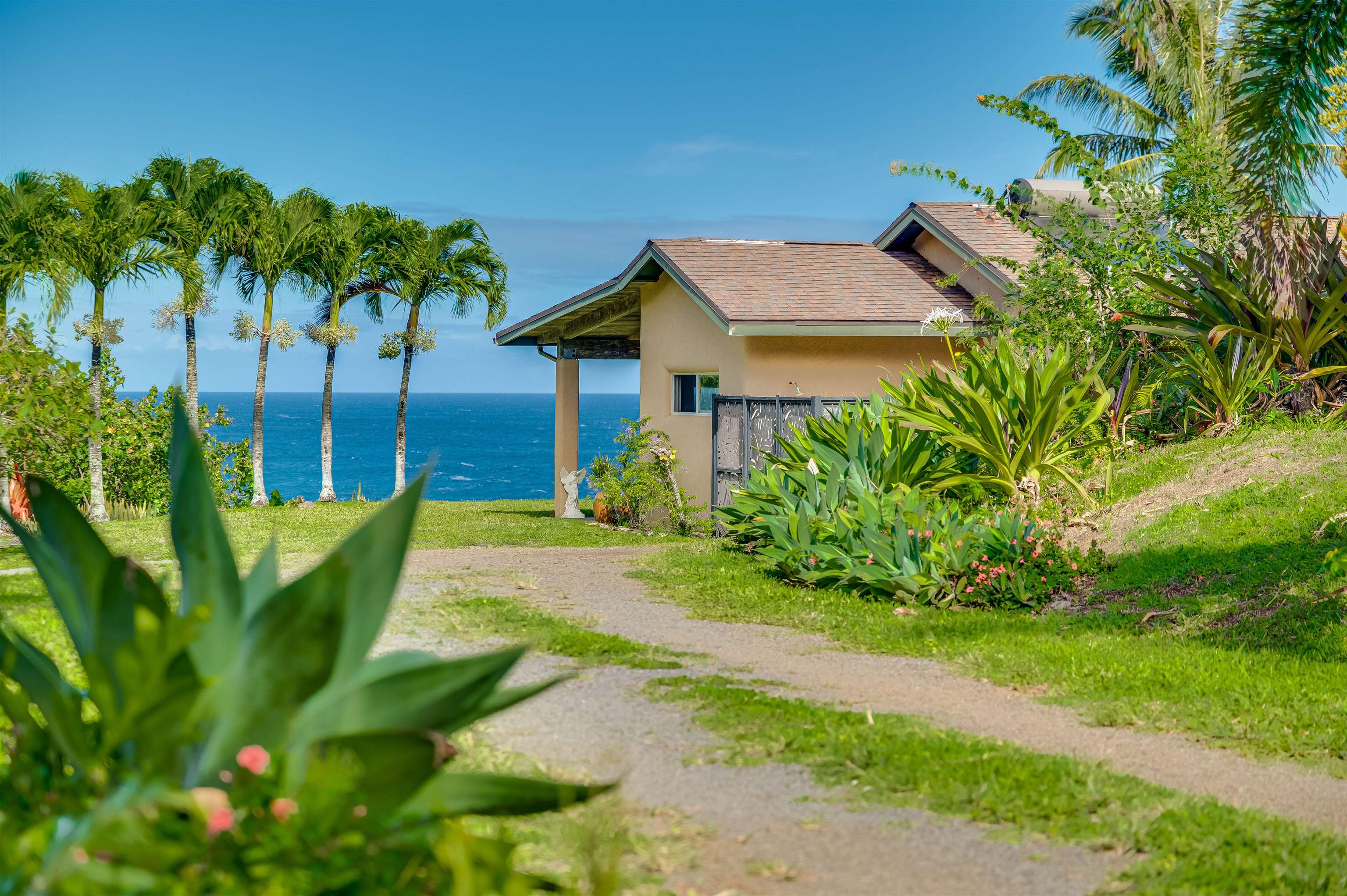 1004 North Honokala Road, Unit B Haiku, HI 96708 - Photo 8 of 49 a front view of a house with garden