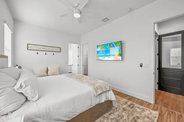 a bedroom with a bed and a painting on the wall