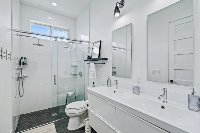 a bathroom with a sink toilet and shower