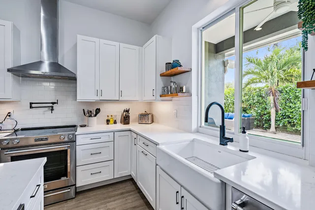 a kitchen with a sink stove and cabinets