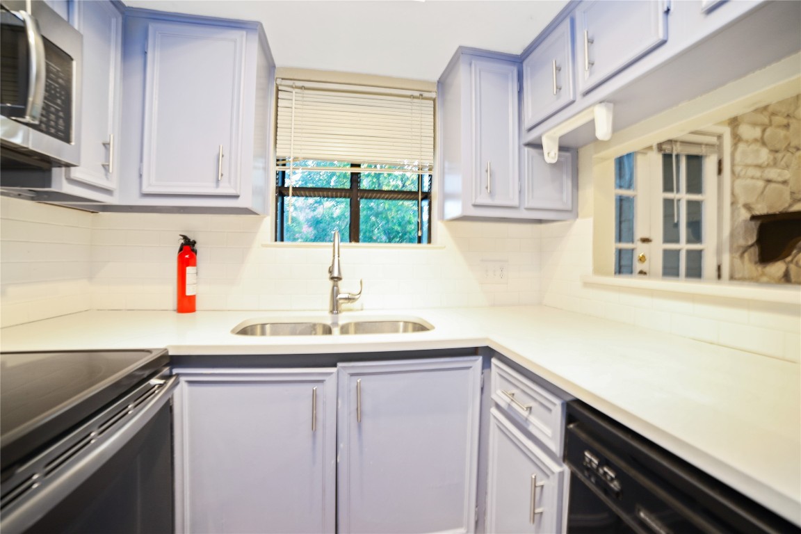 3506 Speedway, Unit 301 Austin, TX 78705 - Photo 3 of 10 a kitchen with stainless steel appliances a sink and cabinets