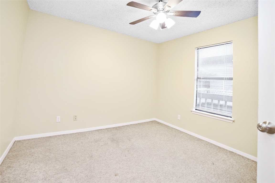 3506 Speedway, Unit 301 Austin, TX 78705 - Photo 6 of 10 an empty room with a window and a fan