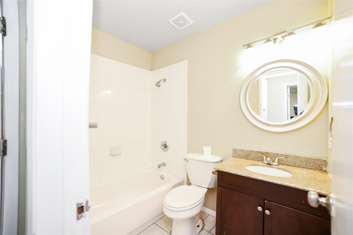 3506 Speedway, Unit 301 Austin, TX 78705 - Photo 7 of 10 a bathroom with a granite countertop toilet a sink and a mirror