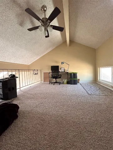 a living room with furniture and a ceiling fan