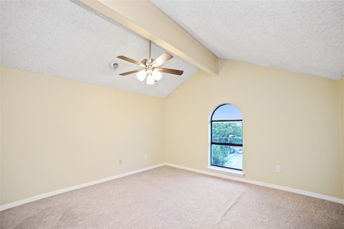 3506 Speedway, Unit 301 Austin, TX 78705 - Photo 9 of 10 an empty room with a chandelier fan and windows