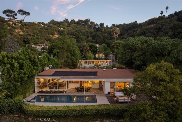 an aerial view of house with yard and outdoor seating