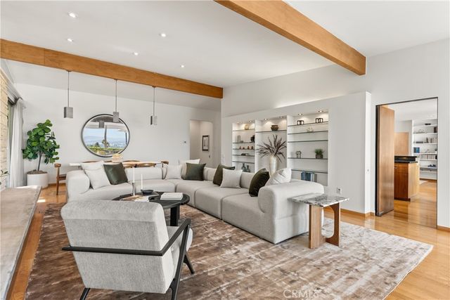 a living room with furniture a rug and a clock