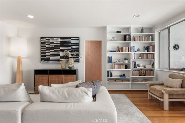 a living room with furniture and a book shelf