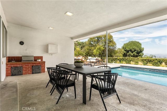 a dining room with furniture and a floor to ceiling window