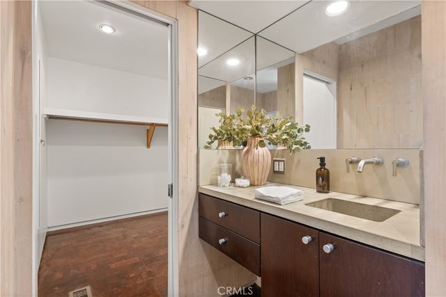 a bathroom with a granite countertop sink and a mirror