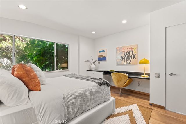 a bedroom with a bed and a chair