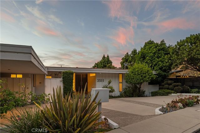 a front view of house with a garden
