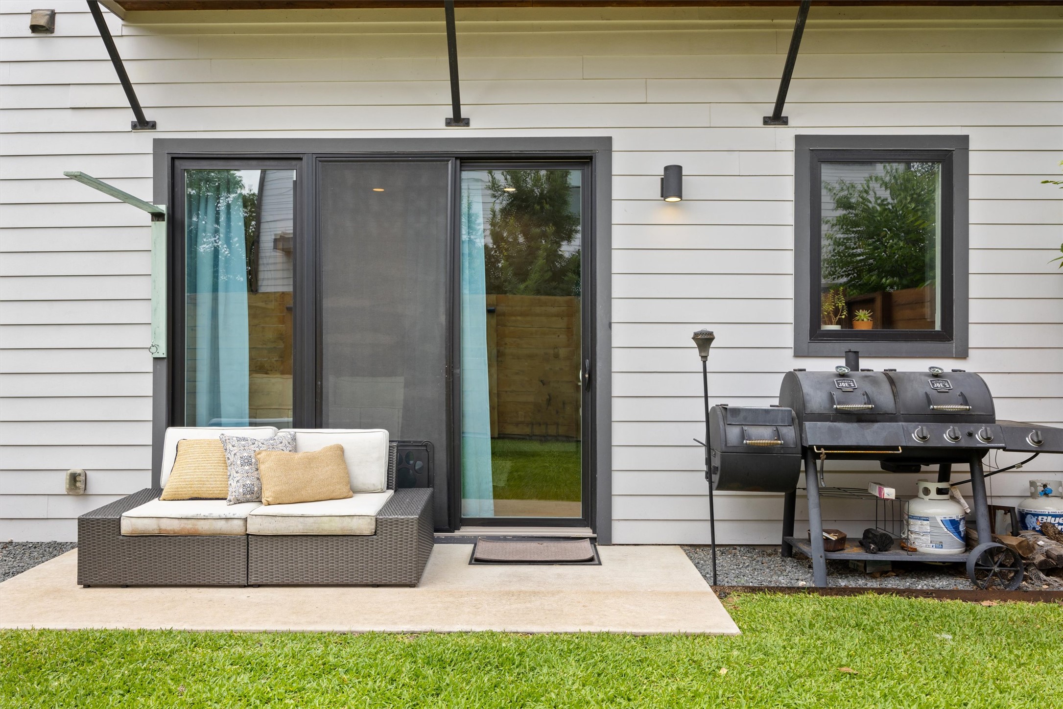 1116 Stobaugh Street, Unit B Austin, TX 78757 - Photo 32 of 38 Sliding glass doors create a seamless connection between indoor and outdoor living.