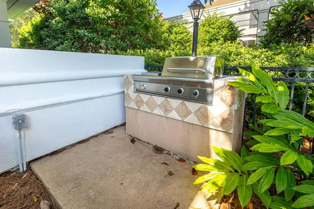 a view of a white house with a large tree