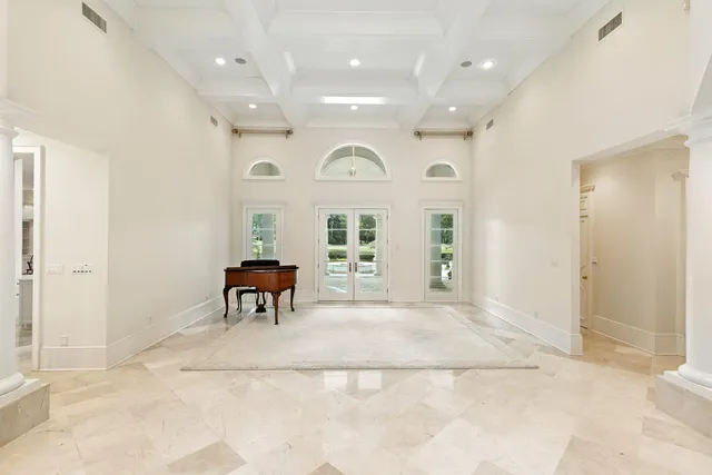 a view of empty room with wooden floor and windows