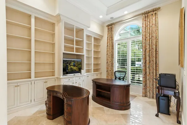 a kitchen with a sink a stove a refrigerator and white cabinets
