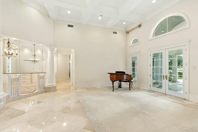 a view of a dining room with furniture and a chandelier