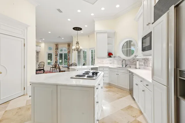 a living room with furniture a rug and a chandelier
