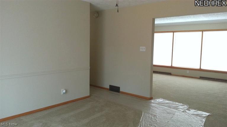 1998 Wyndham Road Akron, OH 44313 - Photo 10 of 25 The dining room, located just off the kitchen and living room. Hallway to the left leads to the bedrooms. New carpet, paint, ceiling fan/light combo, slider doors to the rear deck.