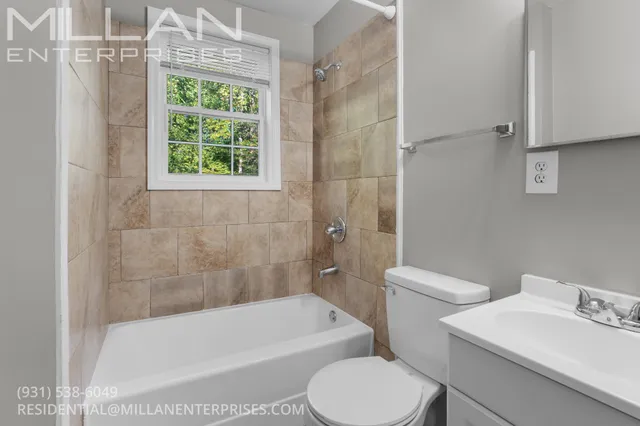 a white bath tub sitting next to a white toilet