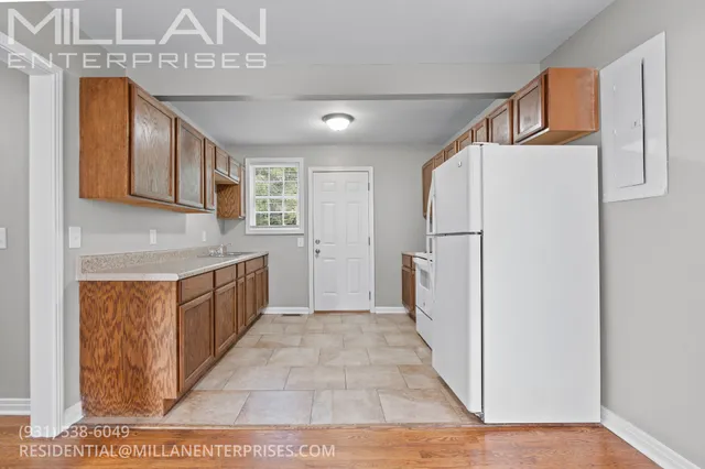 a kitchen with stainless steel appliances granite countertop a refrigerator a sink and a stove