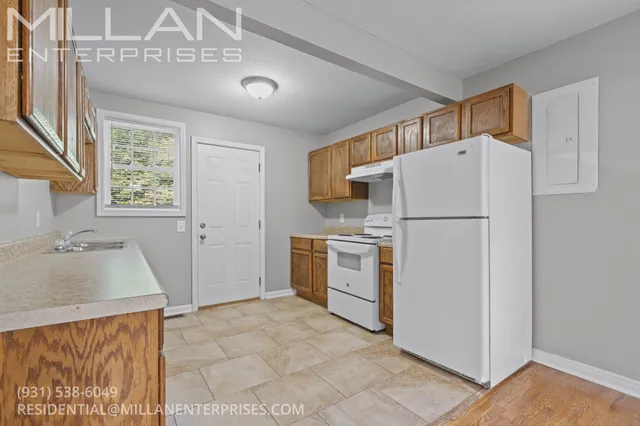 a kitchen with a refrigerator sink stove and cabinets