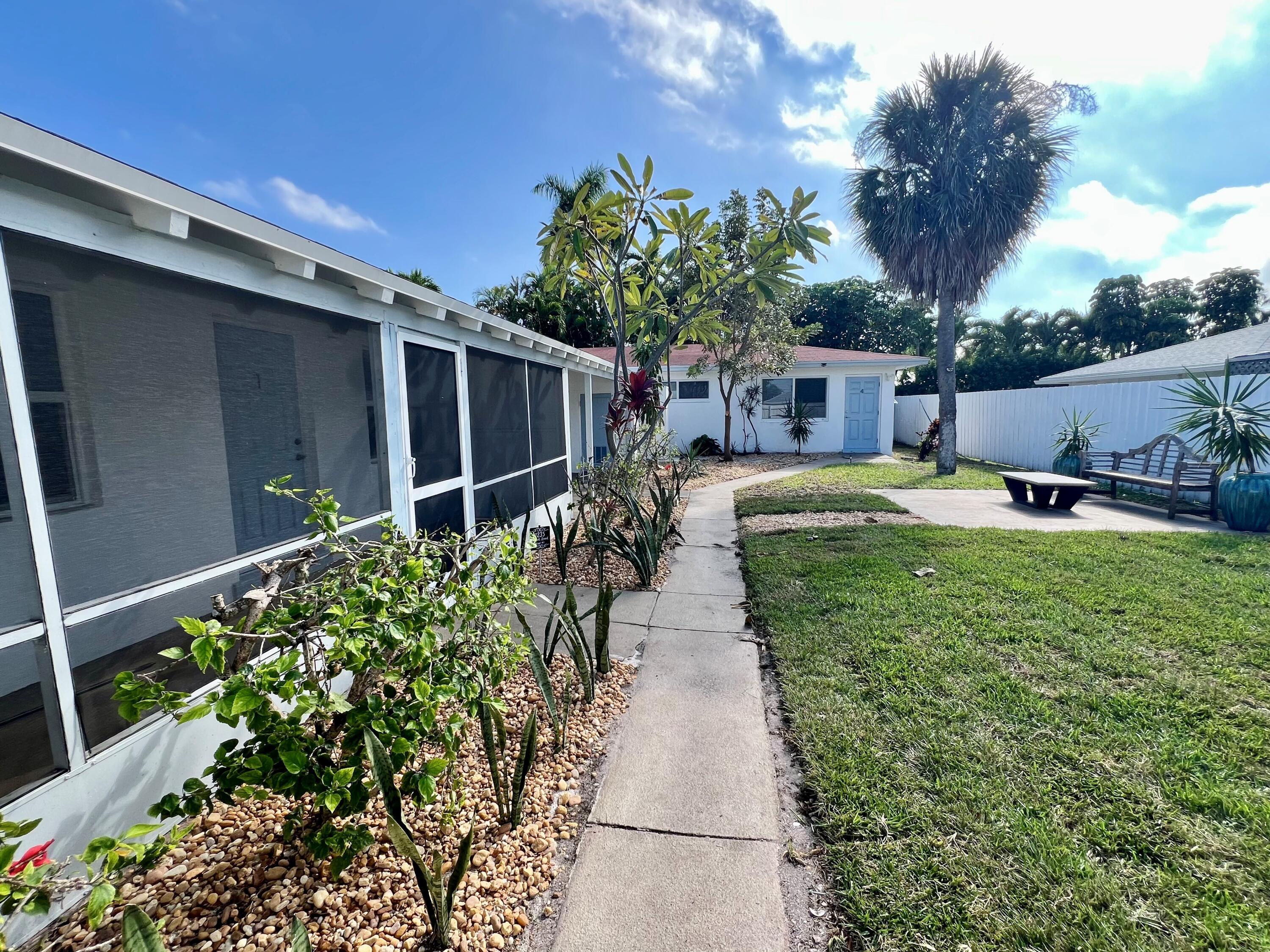 1235 Beach Road, Unit 4 Singer Island, FL 33404 - Photo 3 of 13 a view of a backyard with sitting area