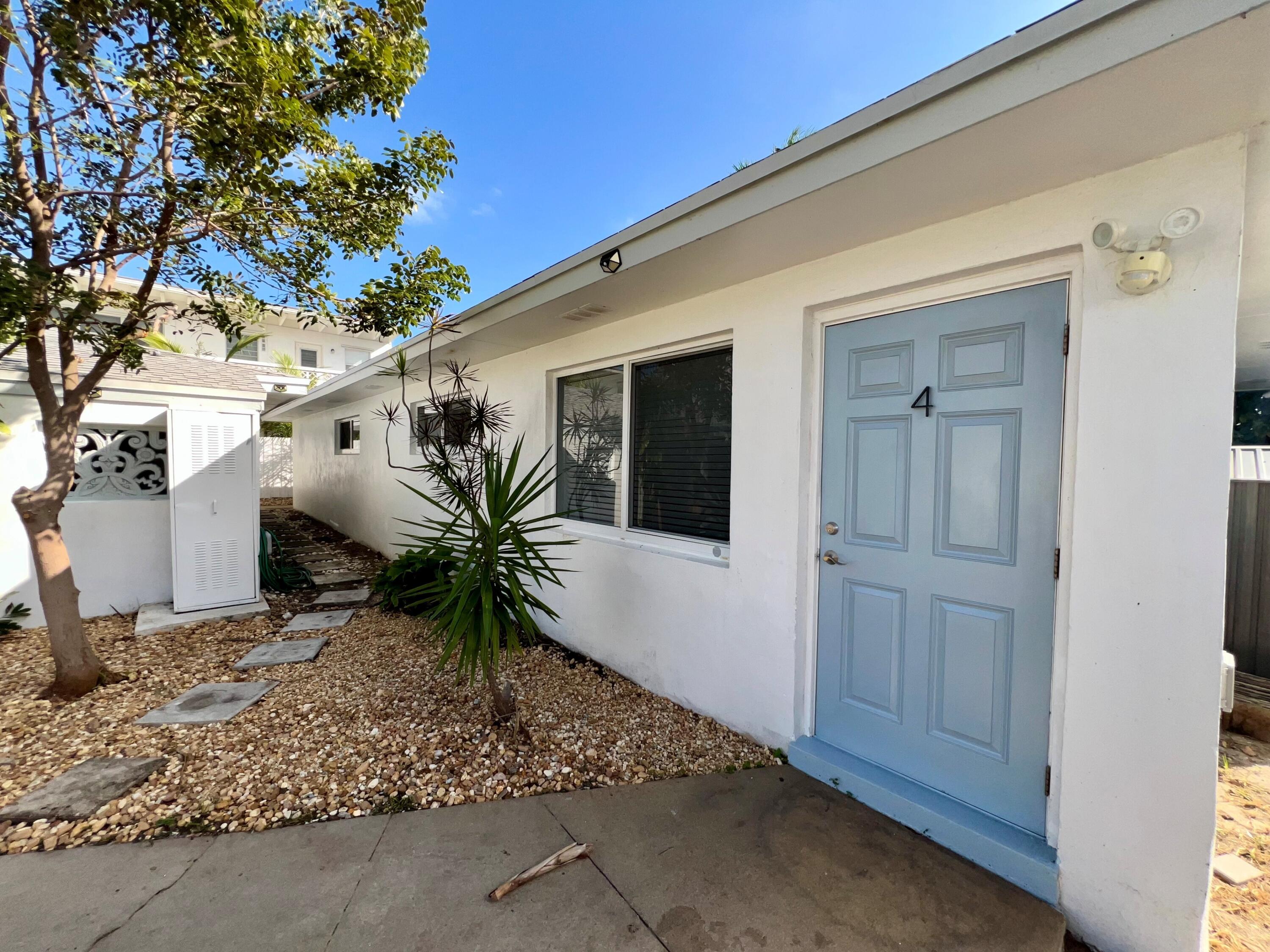 1235 Beach Road, Unit 4 Singer Island, FL 33404 - Photo 5 of 13 a potted plant in front of a door