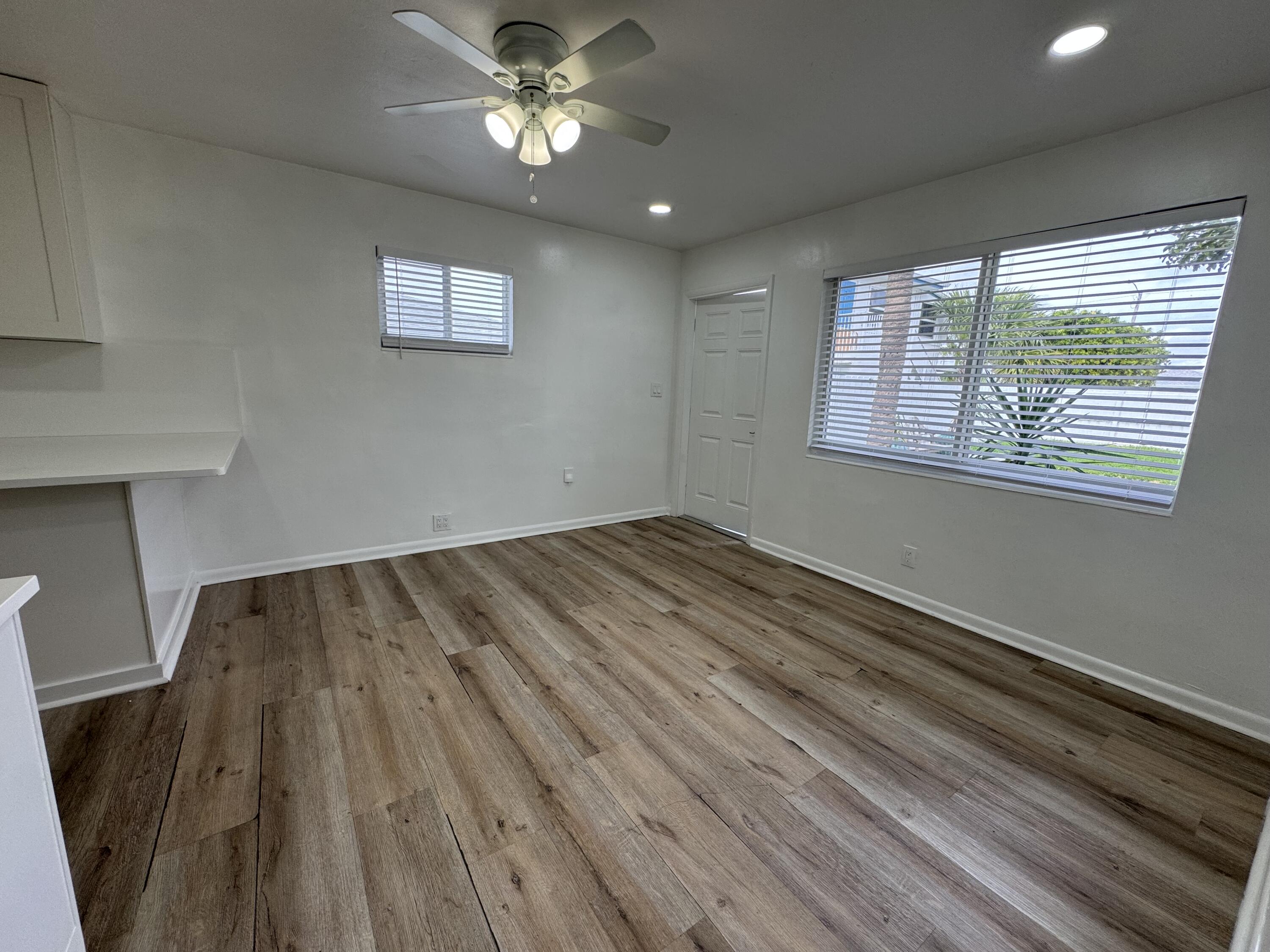 1235 Beach Road, Unit 4 Singer Island, FL 33404 - Photo 7 of 13 a view of empty room with wooden floor and fan