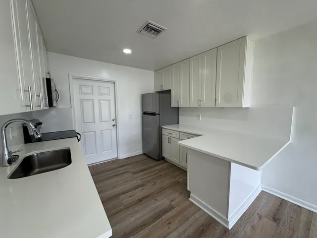 a kitchen with a sink a stove and refrigerator