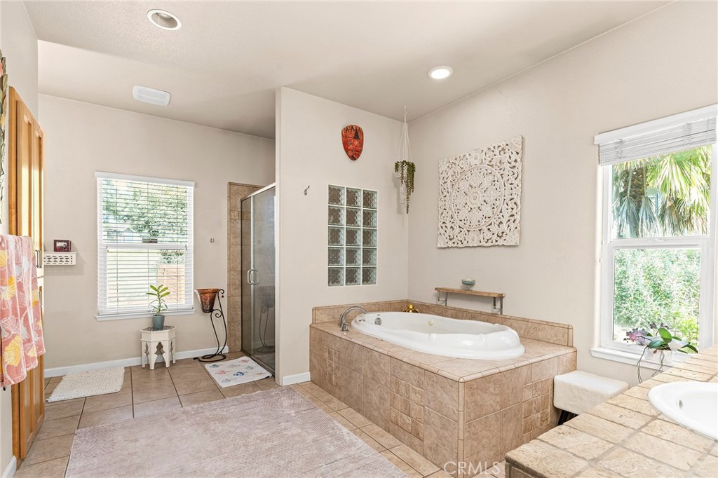 2262 Honey Run Road Chico, CA 95928 - Photo 18 of 74 a bathroom with a tub a sink and a window