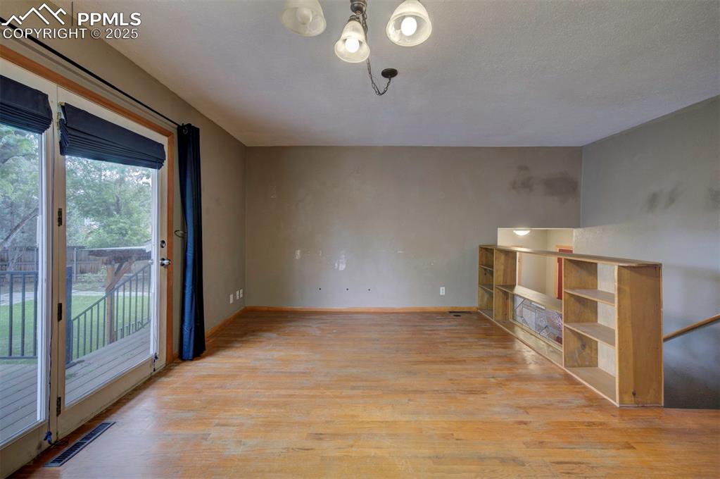 61 Louis Nelson Road Pueblo, CO 81001 - Photo 11 of 50 a view of empty room with wooden floor and fan