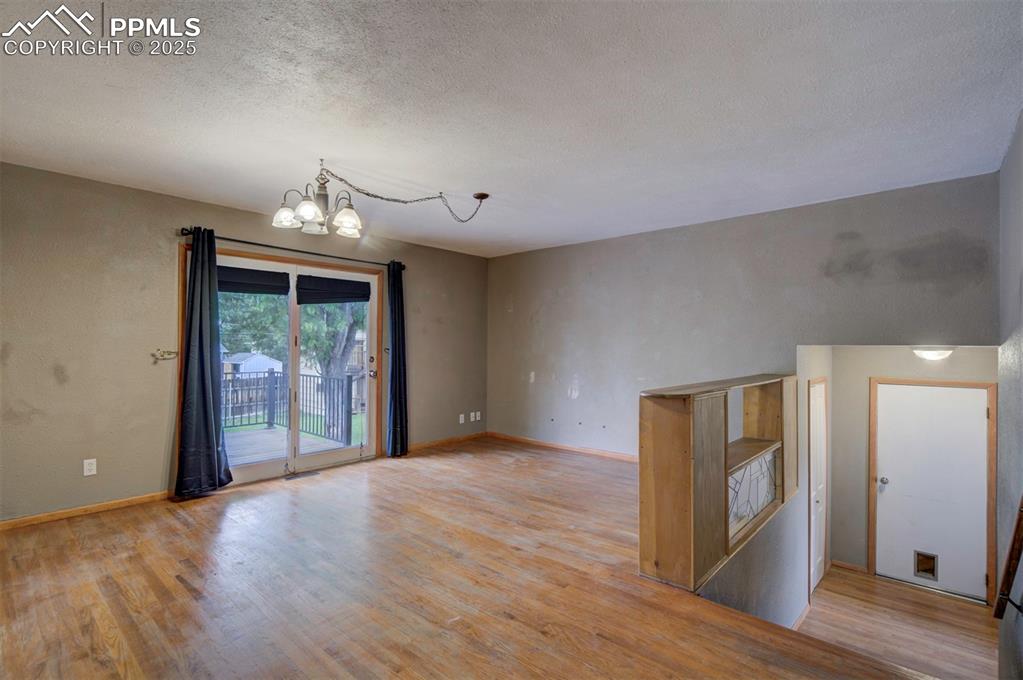 61 Louis Nelson Road Pueblo, CO 81001 - Photo 15 of 50 a view of an empty room with wooden floor and a window