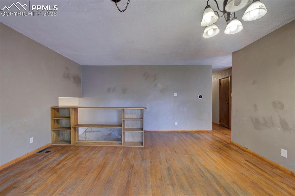 61 Louis Nelson Road Pueblo, CO 81001 - Photo 17 of 50 wooden floor in an empty room with a window