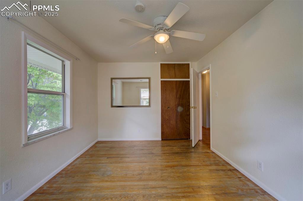 61 Louis Nelson Road Pueblo, CO 81001 - Photo 18 of 50 wooden floor in an empty room with a window