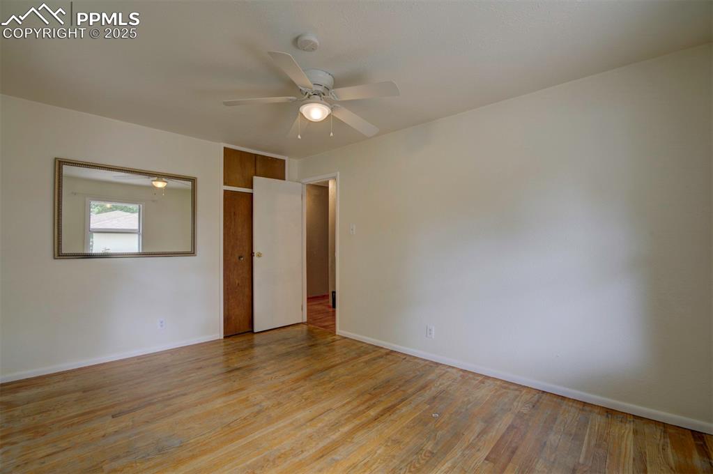 61 Louis Nelson Road Pueblo, CO 81001 - Photo 20 of 50 an empty room with wooden floor fan and windows