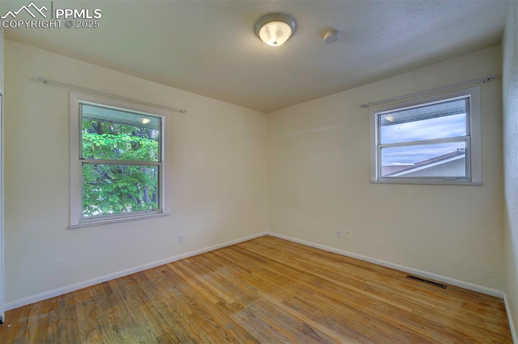 61 Louis Nelson Road Pueblo, CO 81001 - Photo 25 of 50 an empty room with wooden floor and windows