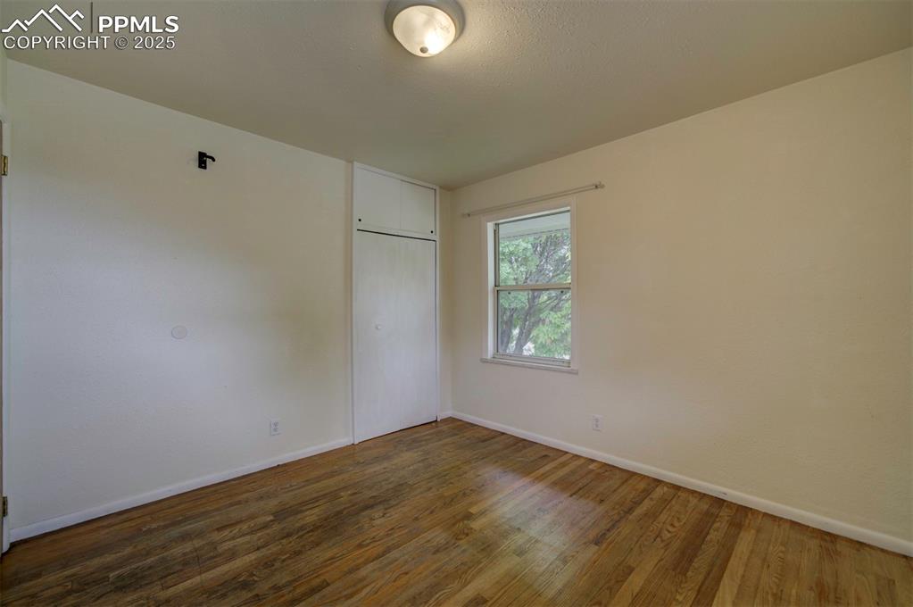 61 Louis Nelson Road Pueblo, CO 81001 - Photo 26 of 50 a view of empty room with wooden floor