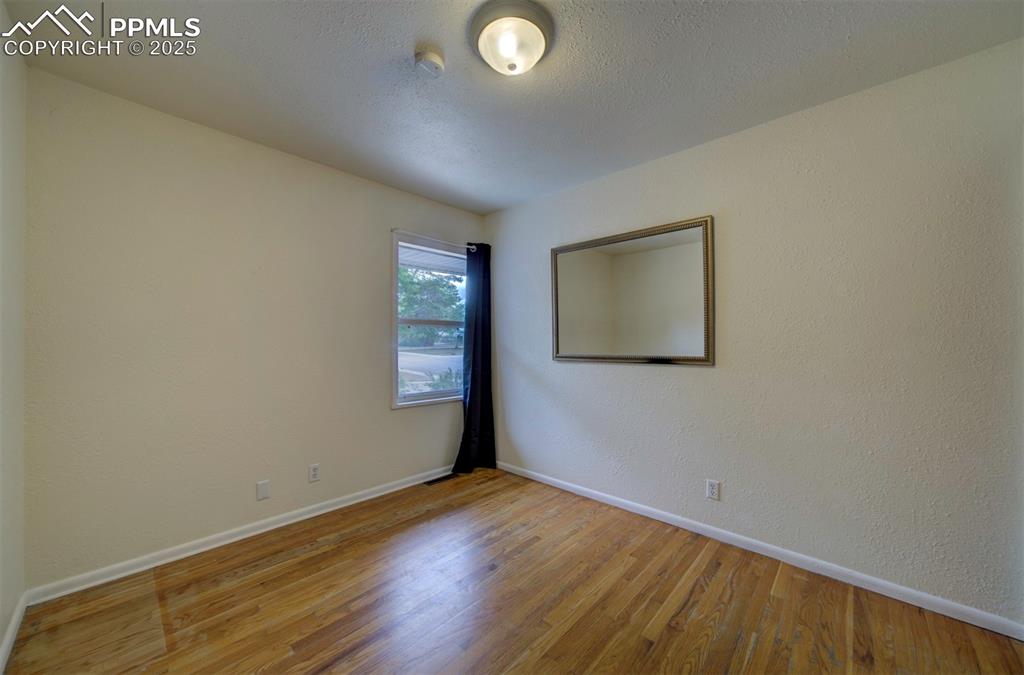 61 Louis Nelson Road Pueblo, CO 81001 - Photo 28 of 50 an empty room with wooden floor and windows